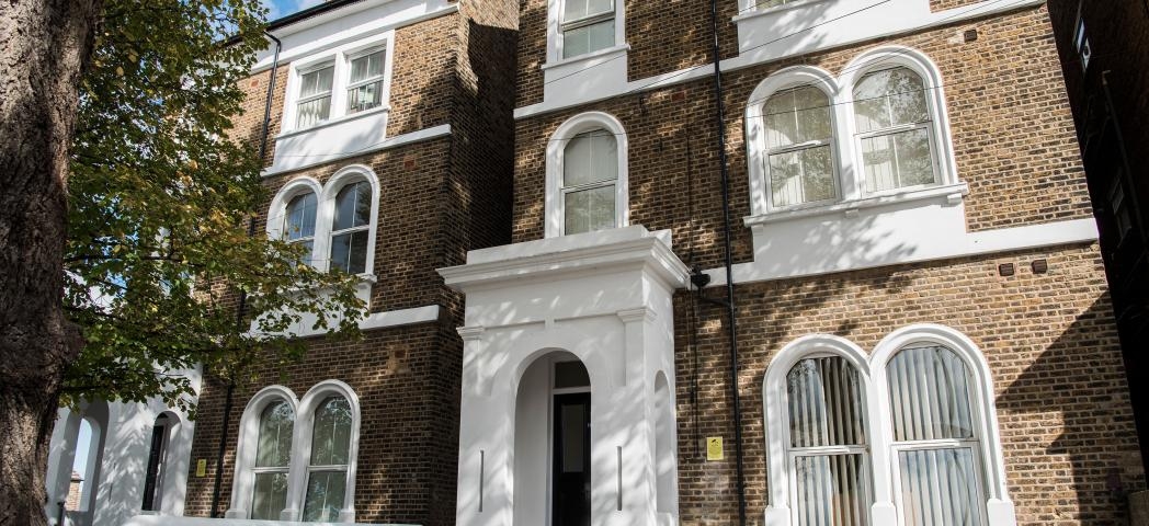 Beautiful, period property featuring multiple arched windows, with a statement porch entry to the care service.