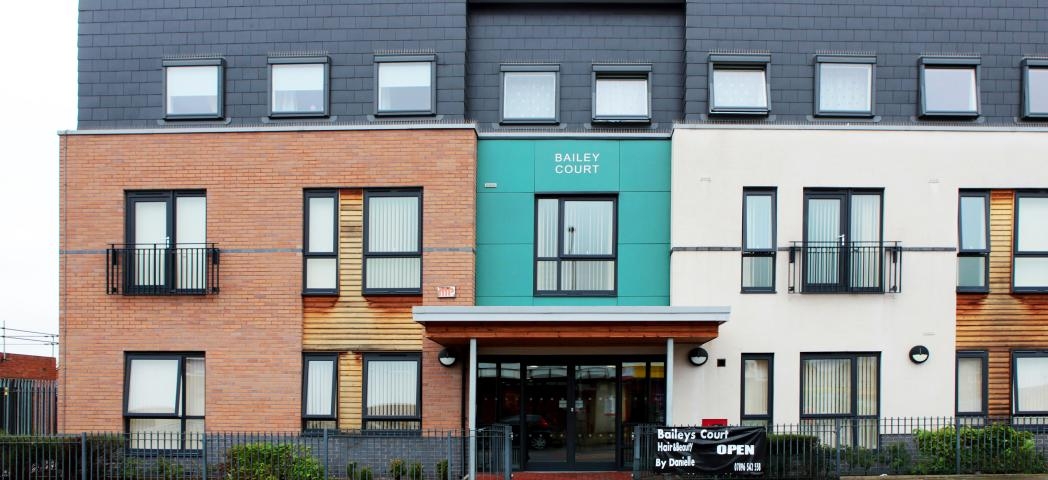 Modernised exterior with a mixture of building materials ranging from, brick, wooden panelling, coloured cladding and painted render create a bright impression of the property.