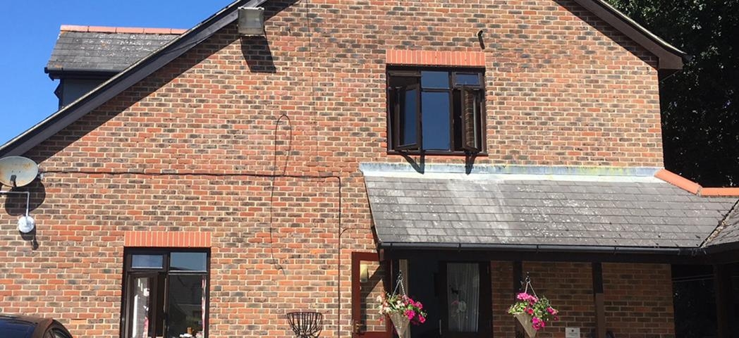 Conventional brick building, with weathering on the porch roof tiling at the supported care facility at the Old Milton Road Flats.