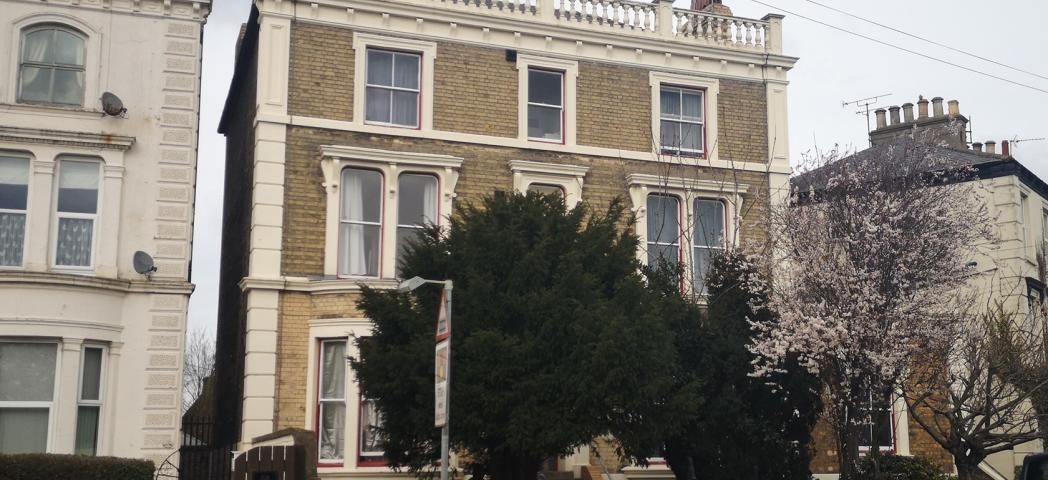 Georgian styled, three storey, detached  property with stepped access to the entrance and gated side entry.