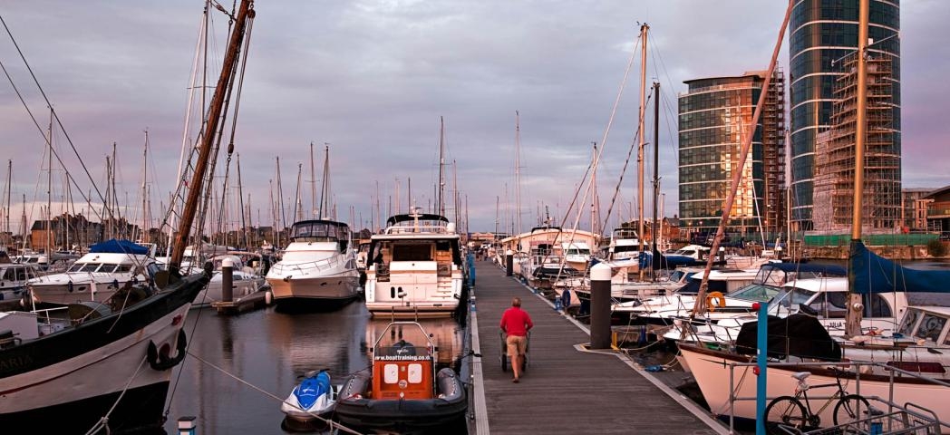 A wide display of yachts of various sizes docked in a busy marina.