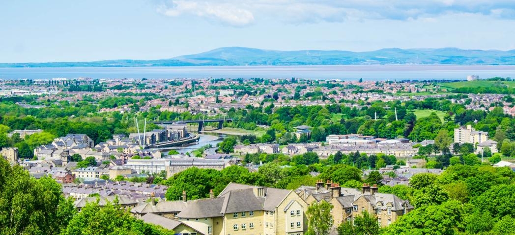The cityscape of Lancaster, with Morecambe Bay in the background.