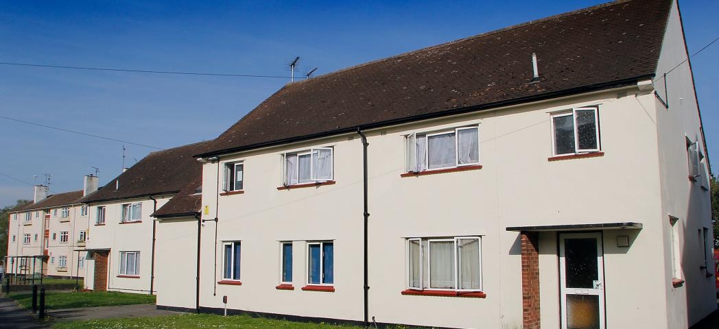 White rendered semi-detached home with manageable grassed front garden and car parking.