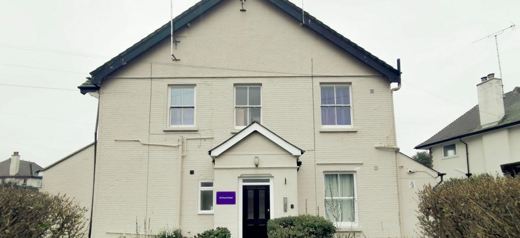 Large semi detached white rendered supported living property.