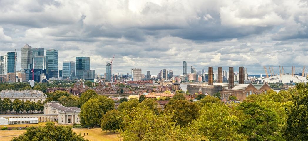 Panoramic views of Greenwich Park and National Maritime Museum, Gardens, University of Greenwich, Old Royal Naval College, River Thames, and the city of London.