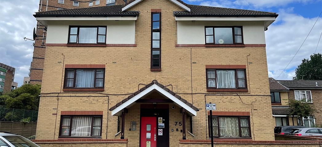 Exterior image of Cleve's Road a 3 story building with a bright red door 