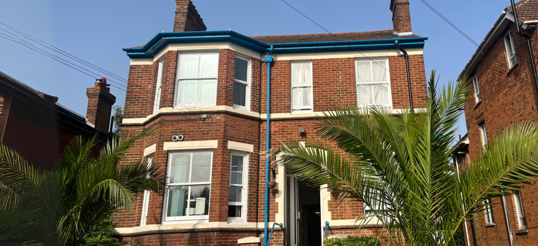 Exterior shot of brick built accommodation with large trees on the front 