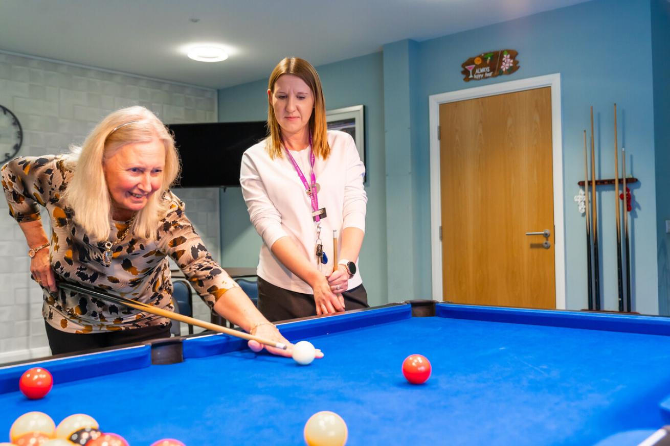 Resident Deborah and Deputy Retirement Communities Manager Heather playing pool together at Baskeyfield House