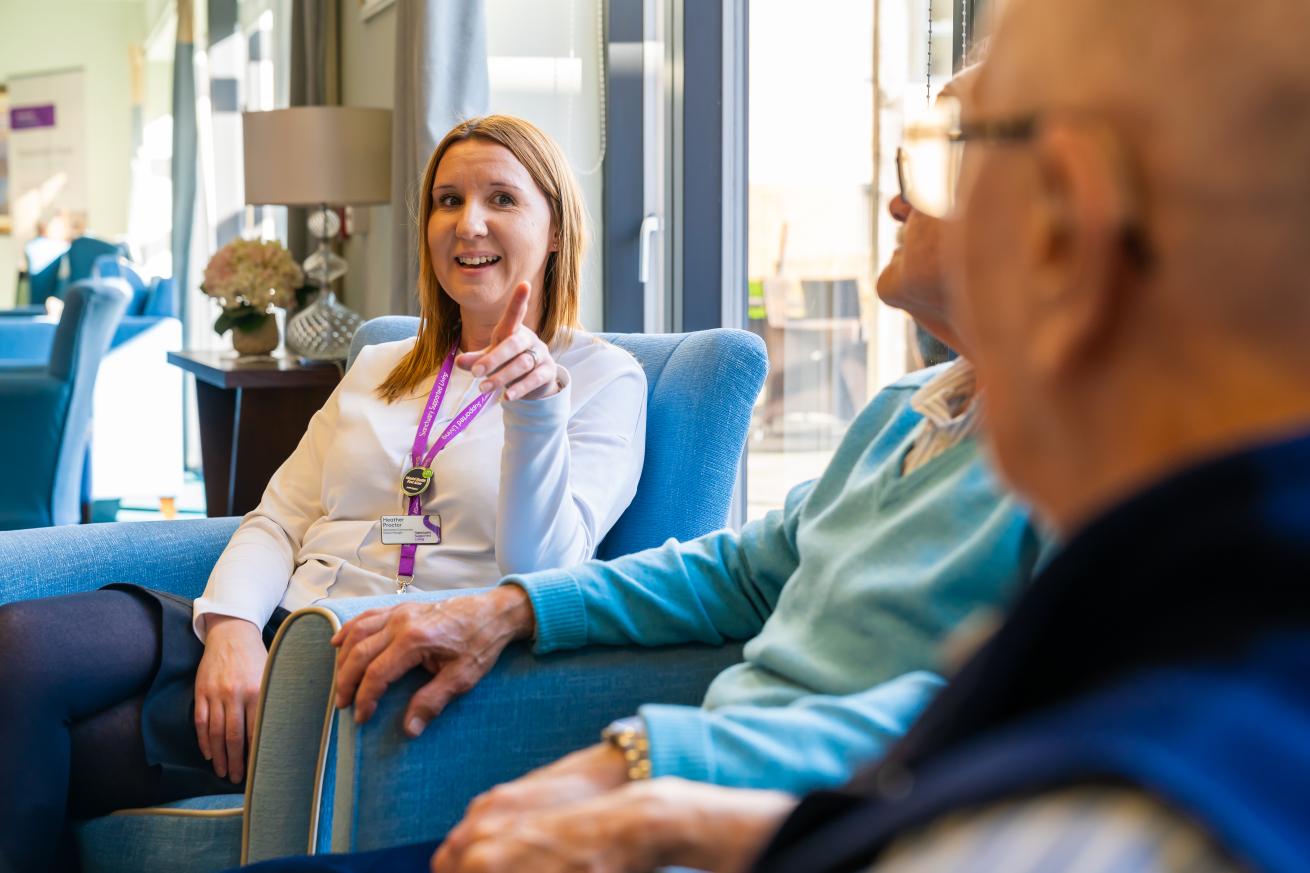A staff member talking with an elderly man