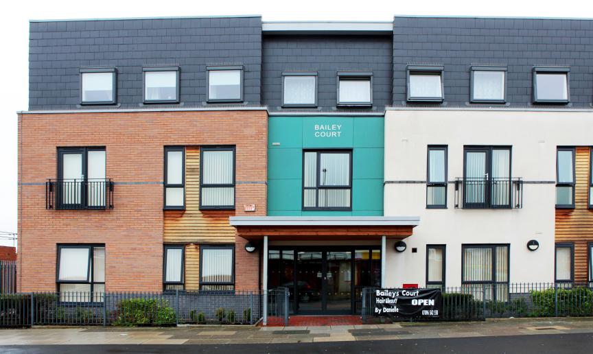 Modernised exterior with a mixture of building materials ranging from, brick, wooden panelling, coloured cladding and painted render create a bright impression of the property.