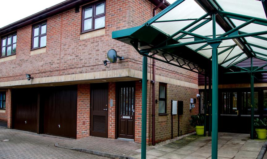 Large brick facility with dropped curbed access points and stepless entry. Providing onsite parking and twelve one-bedroom flats at Hilltop House. 