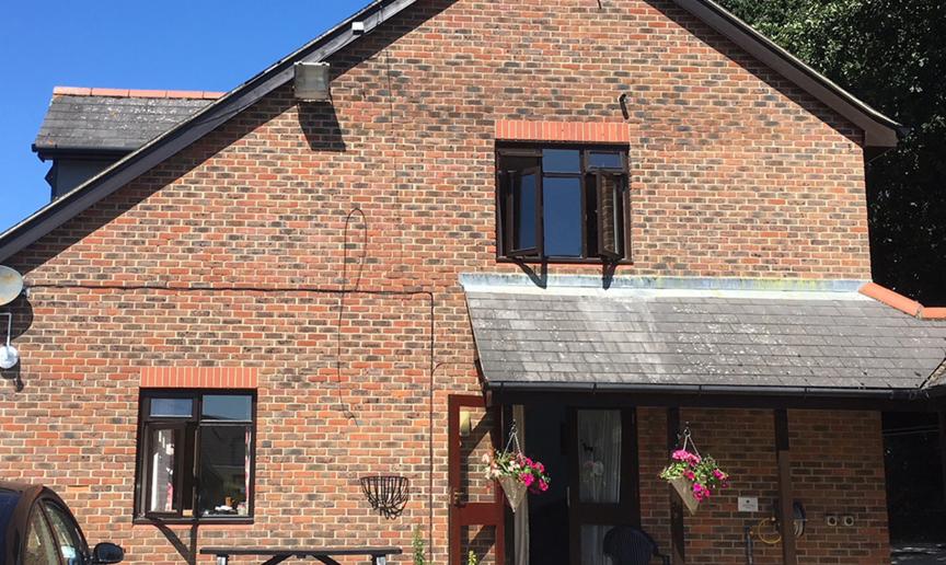 Conventional brick building, with weathering on the porch roof tiling at the supported care facility at the Old Milton Road Flats.