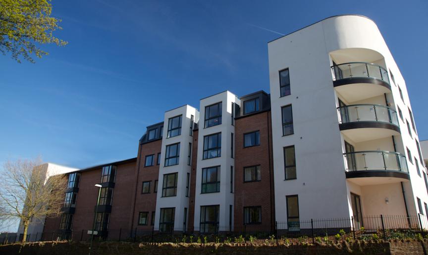 Modern four storey retirement living complex built on a corner plot of land. The corner has been curved to create beautiful balconies for the properties. Traditional red brick as well as white render have been used on the protruding elements of the property.