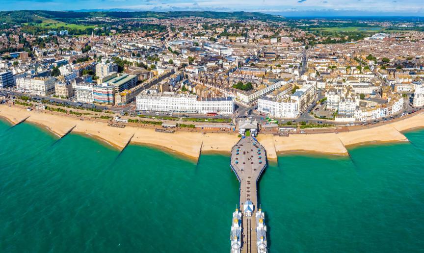 Scenic view of the turquoise sea surrounding the grand pier and town of Eastbourne.