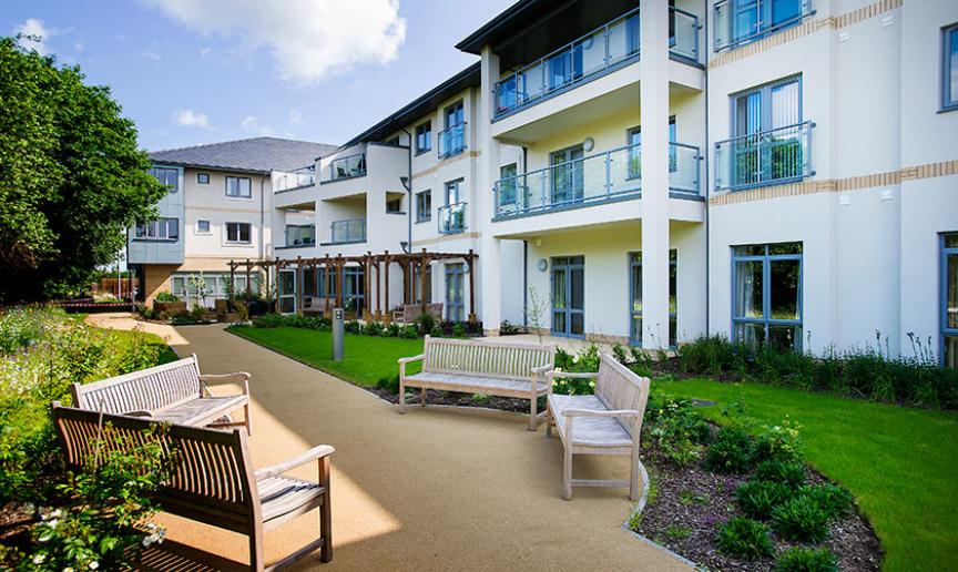 The well-maintained gardens offer a peaceful outdoor escape. The addition of semi-circle bulges to the walkways to allow for a communal seating area.