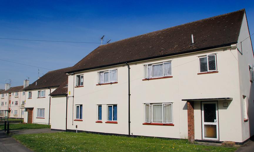 White rendered semi-detached home with manageable grassed front garden and car parking.