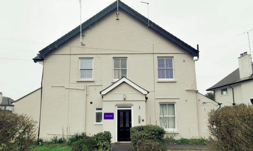 Large semi detached white rendered supported living property.