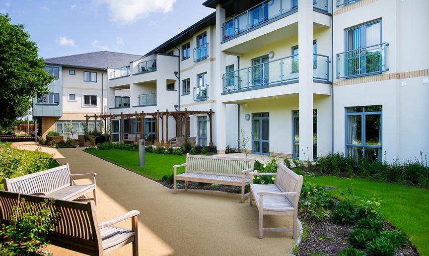 The well-maintained gardens offer a peaceful outdoor escape. The addition of semi-circle bulges to the walkways to allow for a communal seating area.