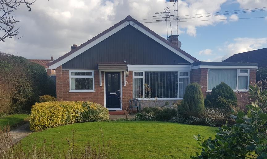 Peaceful bungalow property in Gleneagles Close with single storey extension to the right of the building. Behind a well-kept front garden and curved pathway.