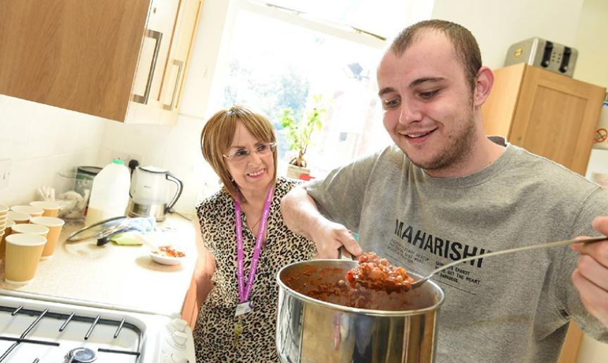 Service user and staff cooking together