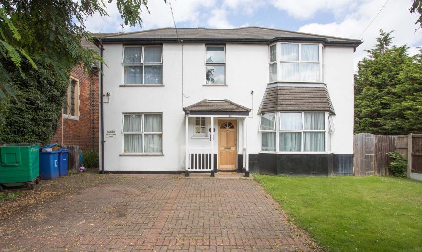 Grandiose white rendered detached home, with elongated driveway and grassed perimeter.