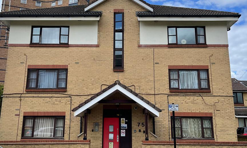 Exterior image of Cleve's Road a 3 story building with a bright red door 