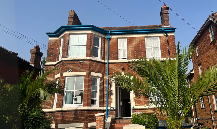 Exterior shot of brick built accommodation with large trees on the front 