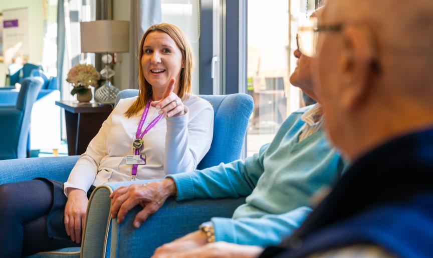 A staff member talking with an elderly man