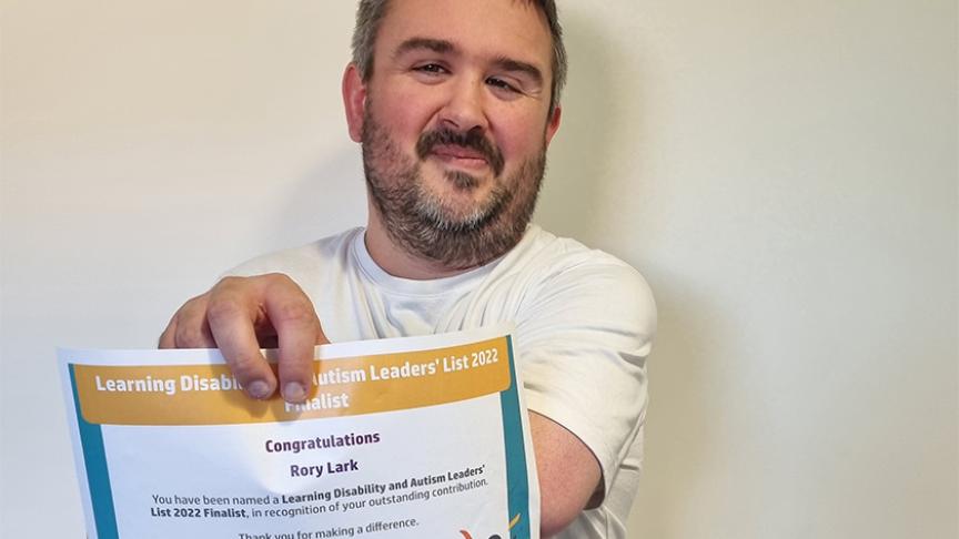 A martial artist from Sanctuary Supported Living’s award-winning disability service, Clover Court, proudly holds out his certificate