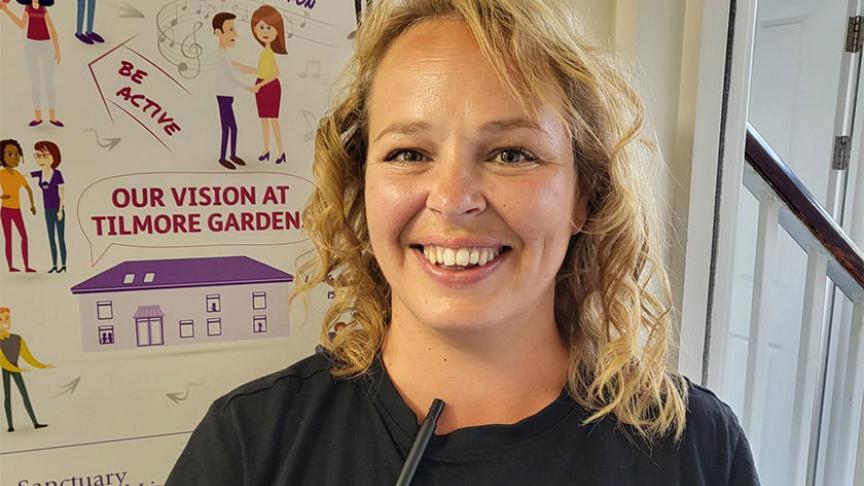 Care and Support Assistant at Tilmore Gardens, smiling at the camera 