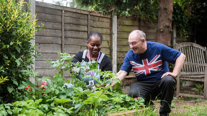 Support worker and resident in the garden at Compton Road