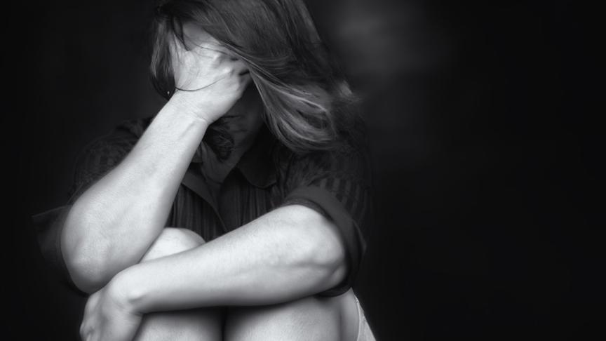 Stock image of a woman covering her face with her hands