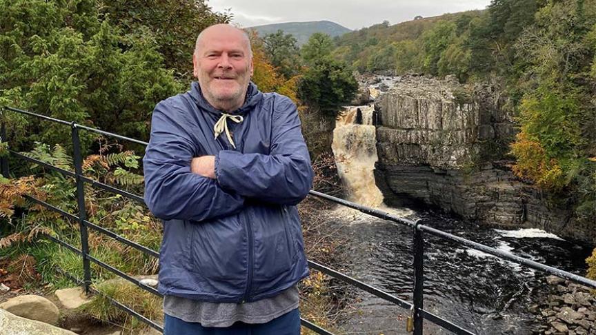 Station Road resident standing in front of a waterfall