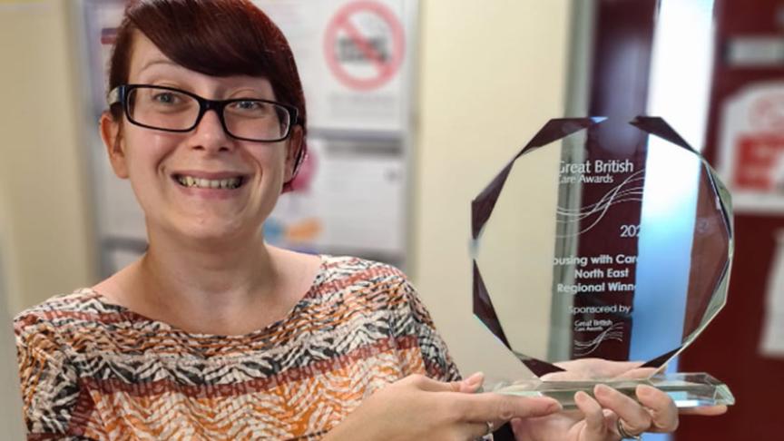 Sanctuary staff member holding her award from the Great British Care Awards