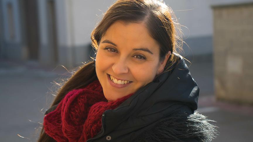 A lady looking into the camera smiling