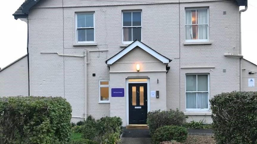 Exterior of Church Road a white double fronted house with a porch