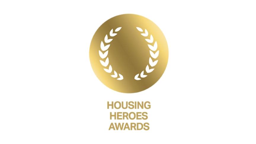 Gold circular laurel wreath graphic with the words “Housing Heroes Awards” underneath