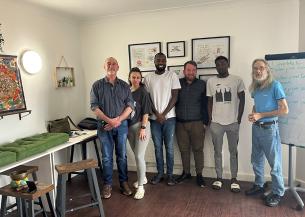 Residents and staff at Queen Elizabeth Way celebrate the opening of their new wellbeing room with a guest speaker from the Colchester Buddhist Centre.