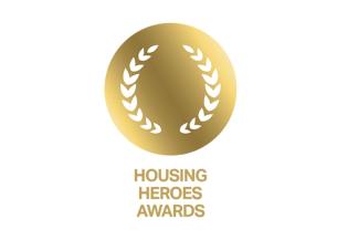 Gold circular laurel wreath graphic with the words “Housing Heroes Awards” underneath