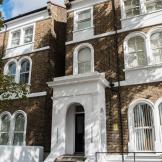 Beautiful, period property featuring multiple arched windows, with a statement porch entry to the care service.