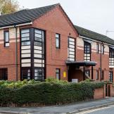 Red and yellow brick facility containing 10 fully furnished bedrooms, providing short-term and longer-term support, at Aldam House and Cottage.