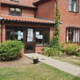 A statement brick-built residence, with different elevation levels and clay roof tiles. With an inviting front garden, consisting of seating area and homely plants.