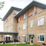 The multi elevational building uses a mixture of yellow brick and wooden panelling to create a step effect to the property. The property goes from a two storey into a three storey and finally into a four, a single storey elevation links out onto the patio garden area.