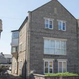 Charming limestone supported housing property at Moorland Road, with left side driveway access to rear parking.