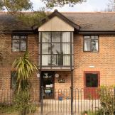 Large detached property with prominent second storey central window and added pointed roof feature. Which sits above the main entrance to the Old Milton Road shared house.