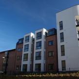 Modern four storey retirement living complex built on a corner plot of land. The corner has been curved to create beautiful balconies for the properties. Traditional red brick as well as white render have been used on the protruding elements of the property.