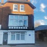 Three storey brick and rendered end of terrace property. With access to the right hand side.