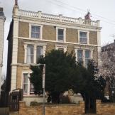 Georgian styled, three storey, detached  property with stepped access to the entrance and gated side entry.