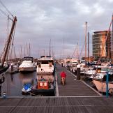 A wide display of yachts of various sizes docked in a busy marina.