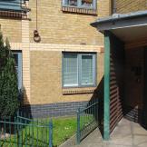 Yellow brick built supported living property with canape sheltering above the entranceway. 